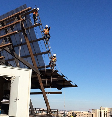 denver roofing company academy roofing working on a commercial building site in 