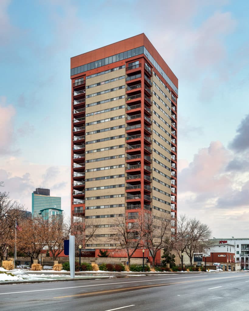 tall orange and tan building in downtown area