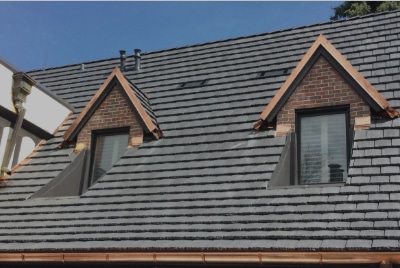 residential roof with two windows and grey roof